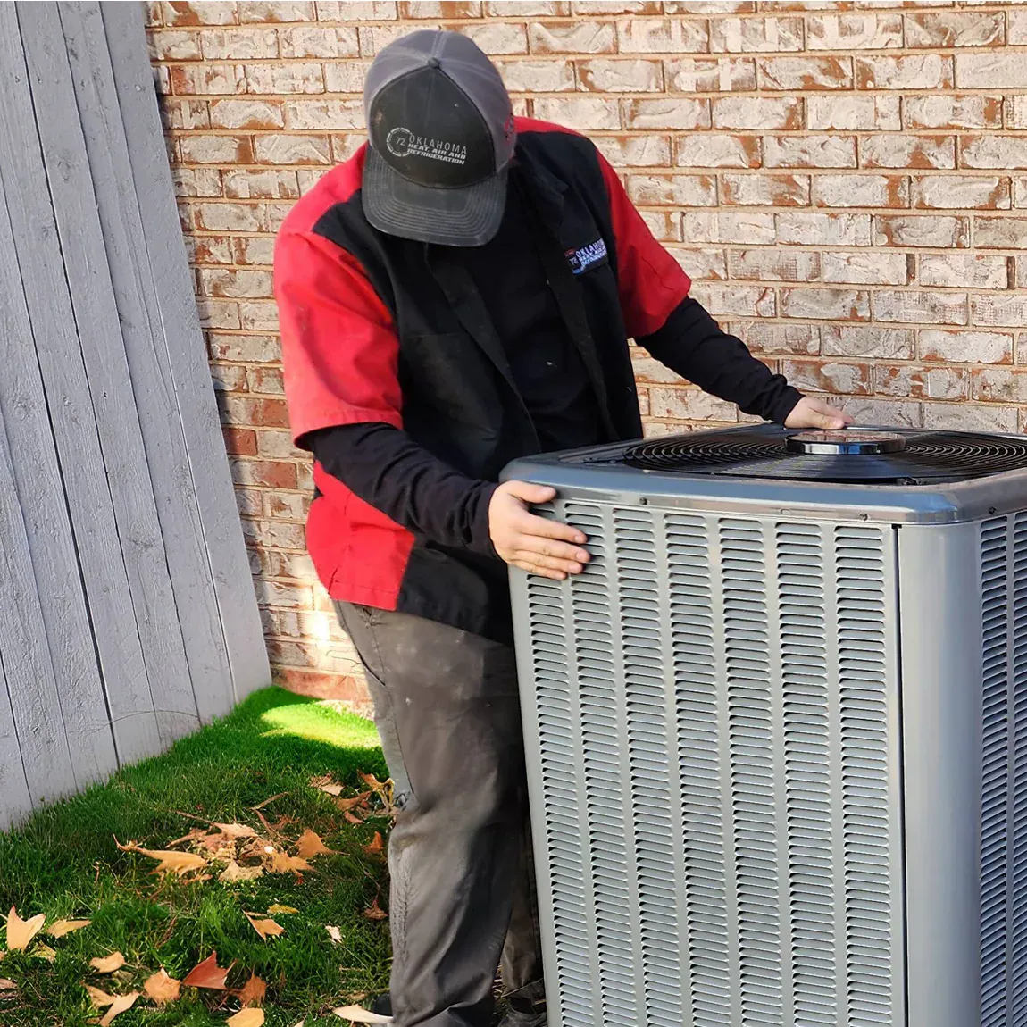 Oklahoma Heat, Air and Refrigeration technician servicing an outdoor HVAC unit