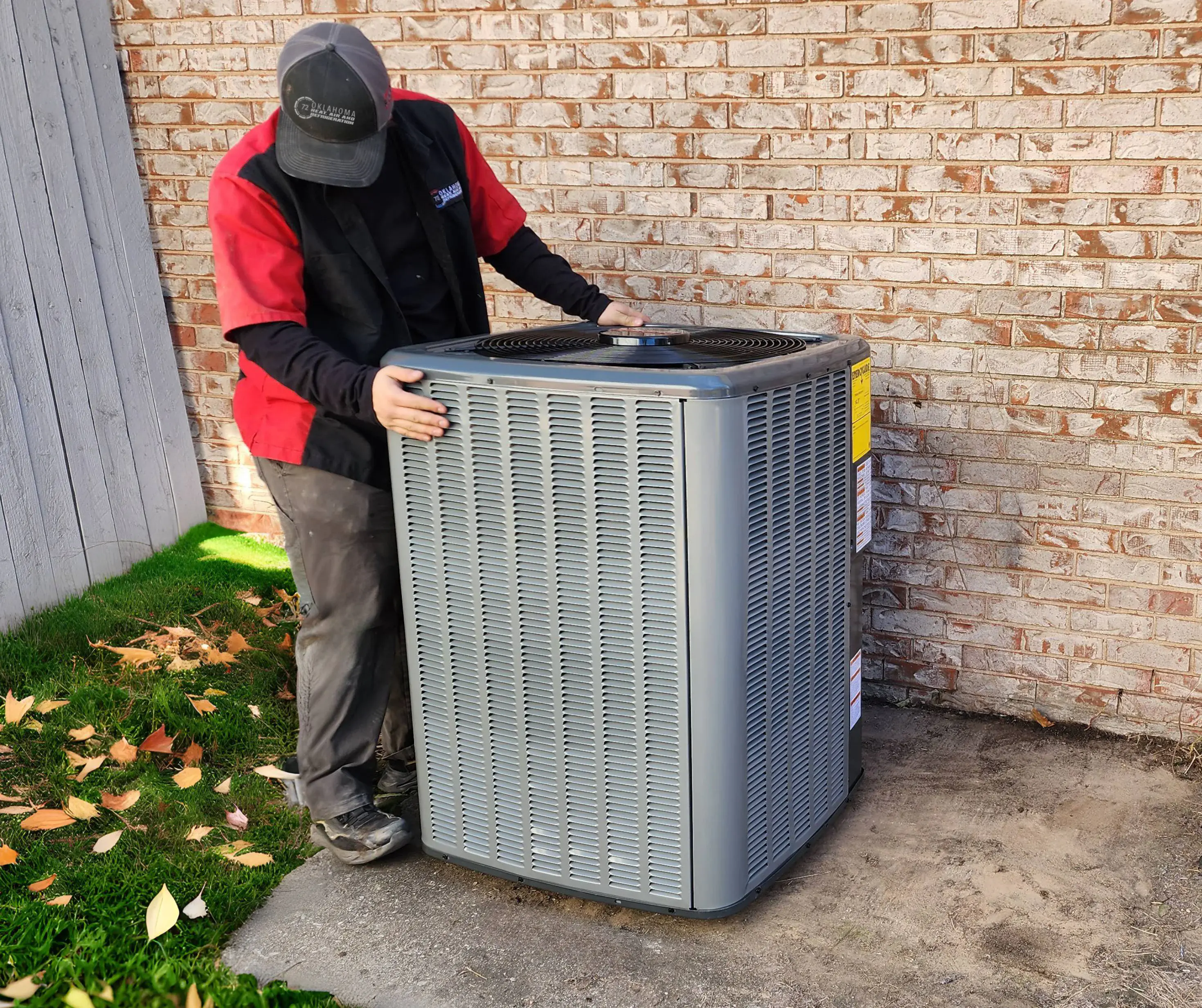 HVAC technician installing an outdoor air conditioning unit