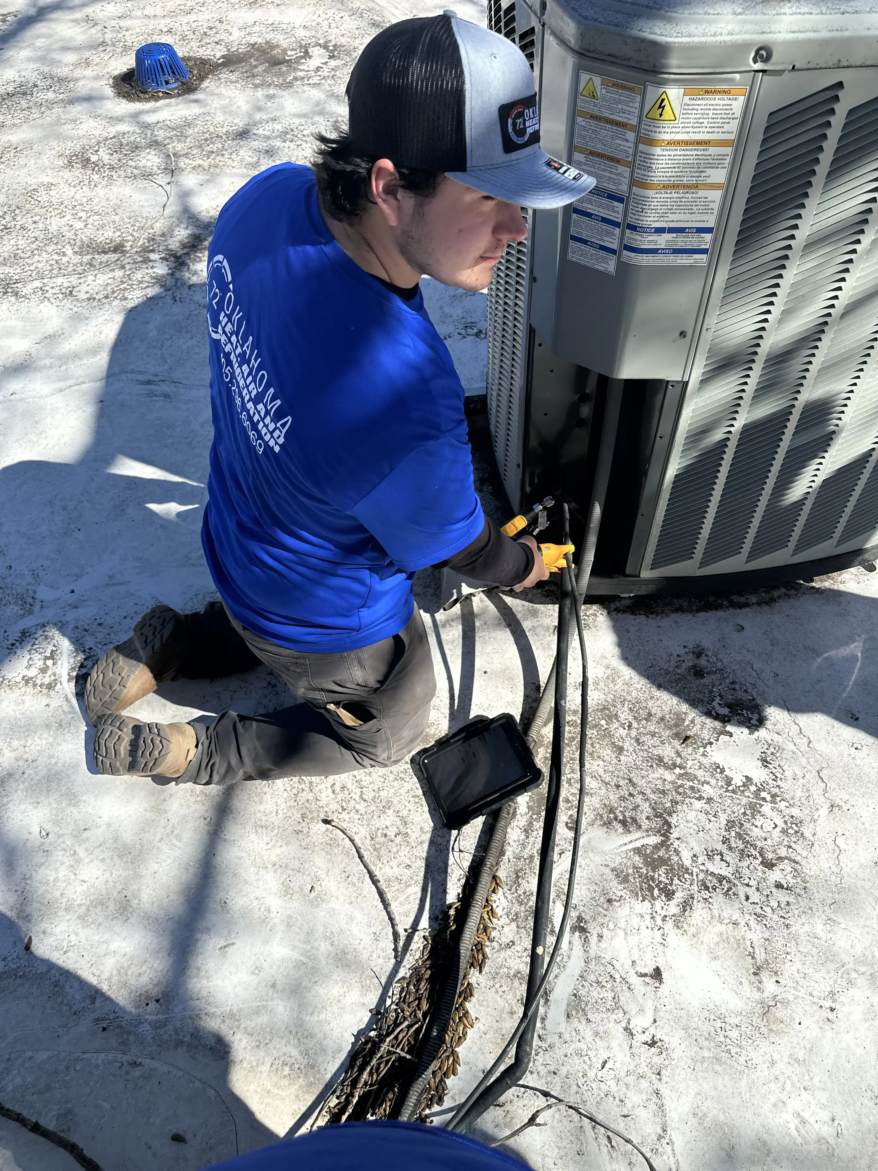 HVAC technician servicing outdoor heating and cooling equipment