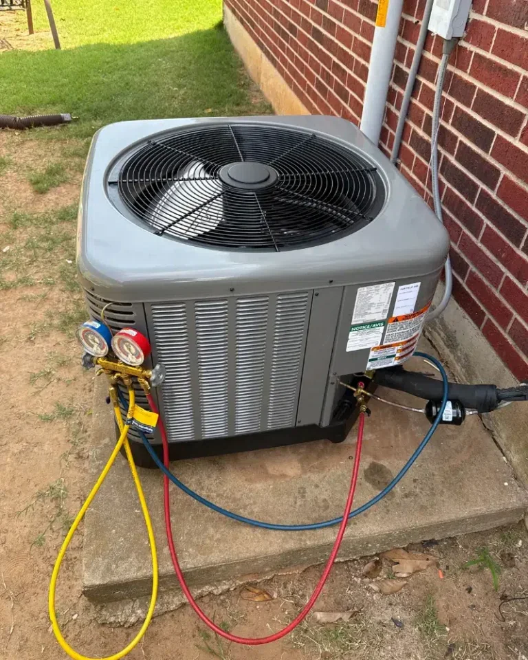 Outdoor air conditioning unit connected to diagnostic gauges